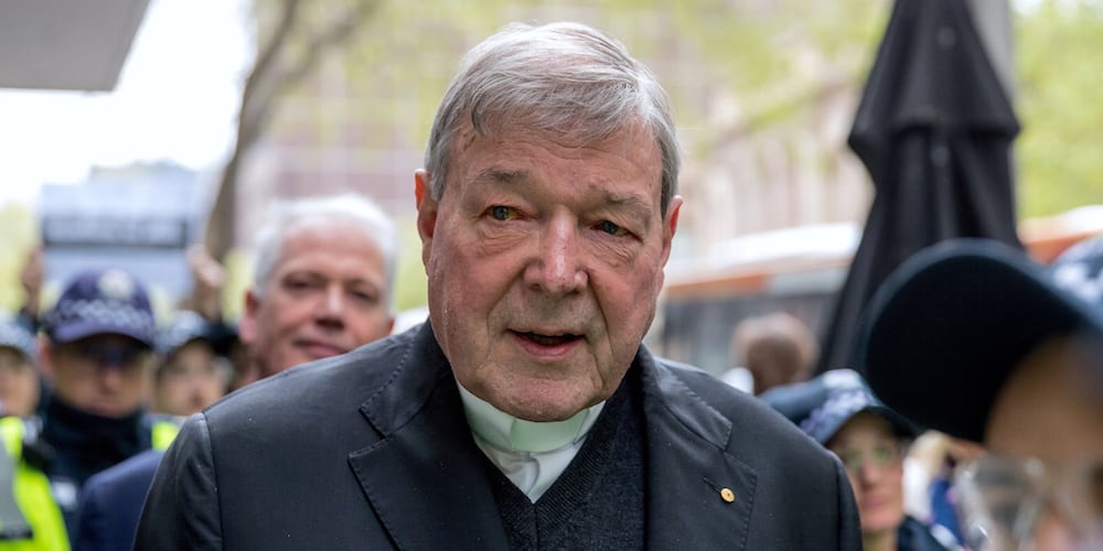 Vatican Treasurer Cardinal George Pell is surrounded by Australian police as he leaves the Melbourne Magistrates Court in Australia, October 6, 2017.    REUTERS/Mark Dadswell - RC13AE49CA90