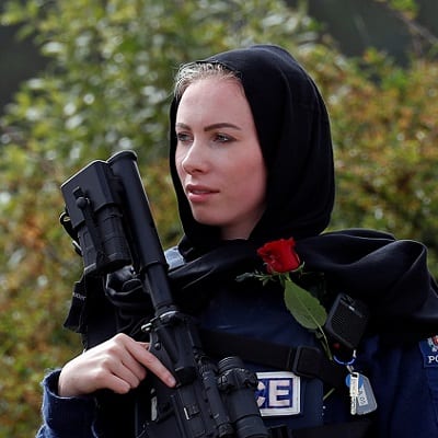 A policewoman is seen as people attend the burial ceremony of a victim of the mosque attacks, at the Memorial Park Cemetery in Christchurch, New Zealand March 21, 2019. REUTERS/Jorge Silva - RC13807E6E90