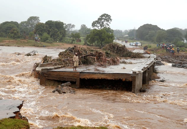 A man looks at a washed away bridge along Umvumvu river following Cyclone Idai in Chimanimani, Zimbabwe March 18, 2019. Photo Credit: REUTERS/Philimon Bulawayo 