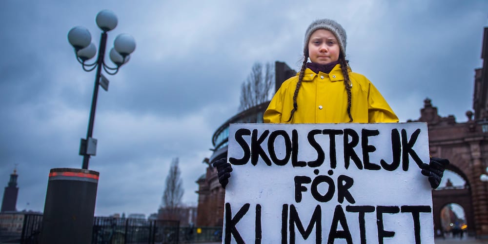15-year-old Swedish girl Greta Thunberg holds a placard reading "School strike for the climate" during a manifestation against climate change outside the Swedish parliament in Stockholm, Sweden November 30, 2018. TT News Agency/Hanna Franzen via REUTERS      ATTENTION EDITORS - THIS IMAGE WAS PROVIDED BY A THIRD PARTY. SWEDEN OUT. NO COMMERCIAL OR EDITORIAL SALES IN SWEDEN. - RC1B38D46450