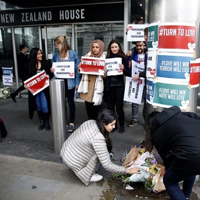 People lay flowers outside New Zealand House, following Christchurch mosque attack in New Zealand, in London, Britain March 15, 2019. REUTERS/Henry Nicholls - RC178C0E1510