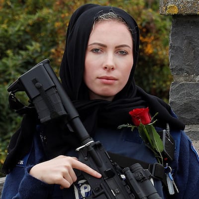 A policewoman is seen as people attend the burial ceremony of a victim of the mosque attacks, at the Memorial Park Cemetery in Christchurch, New Zealand March 21, 2019. REUTERS/Jorge Silva - RC1E23F80630
