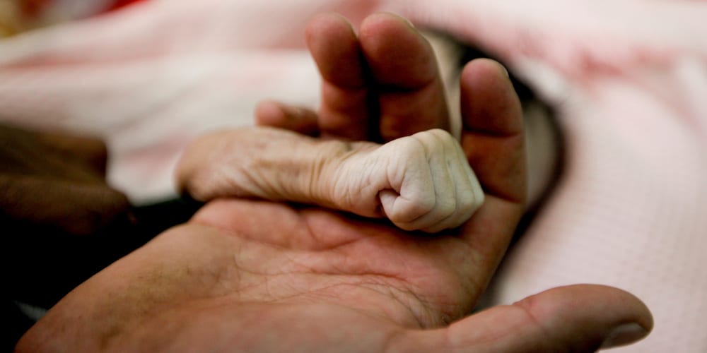ATTENTION EDITORS - VISUAL COVERAGE OF SCENES OF INJURY OR DEATH   Saleh Hassan al-Faqeh holds the hand of his four-month-old daughter, Hajar, who died at the malnutrition ward of al-Sabeen hospital in Sanaa, Yemen, November 15, 2018. REUTERS/Mohamed al-Sayaghi   SEARCH "POY GLOBAL" FOR FOR THIS STORY. SEARCH "REUTERS POY" FOR ALL BEST OF 2018 PACKAGES. TPX IMAGES OF THE DAY. - RC17FC3302B0
