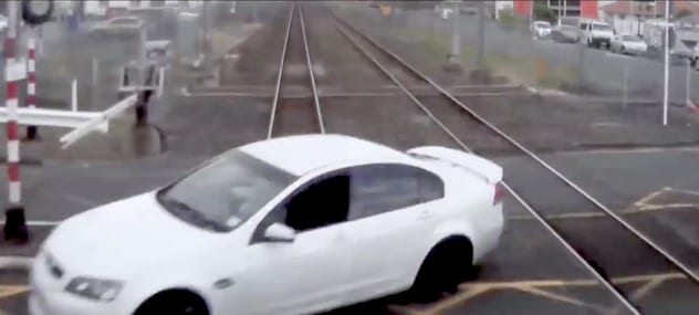 The driver of this car deliberately drove around the barriers to play chicken with a speeding train in the West Auckland suburb of Henderson. KIWIRAIL/TRACKSAFE NZ