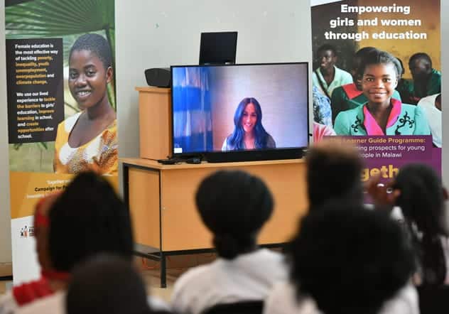 There were cheers followed by chanting as The Duchess of Sussex popped up on a TV screen in a Malawian school. REUTERS