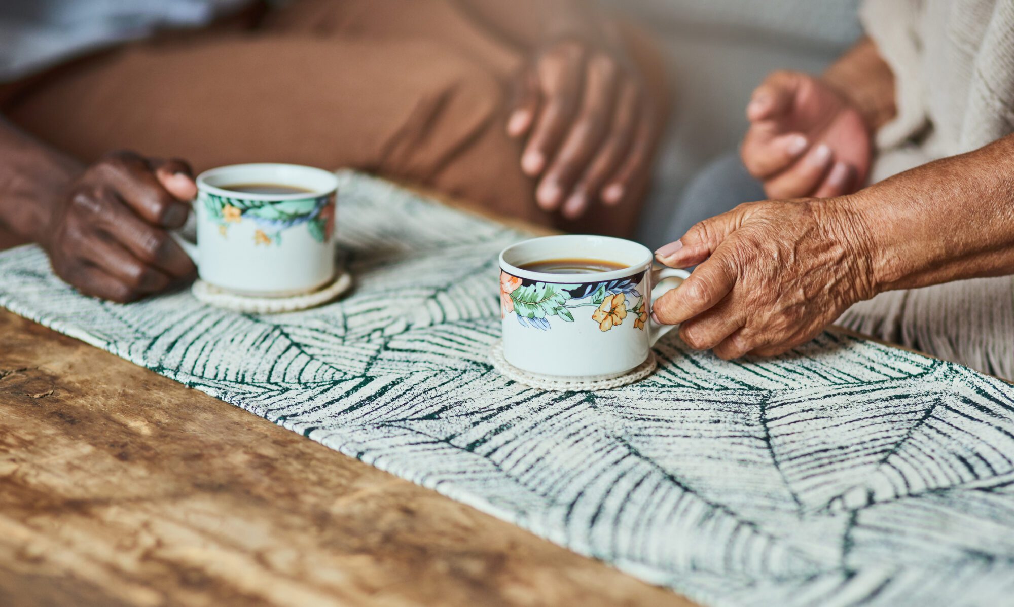 Shot of two unrecognizable elderly people sharing a cup of coffee