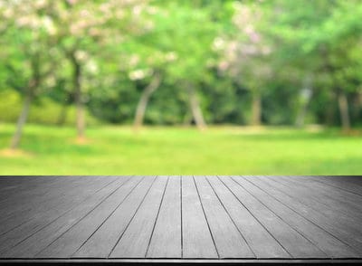 Empty Wooden Platform And Spring Green Blurred Abstract Background
