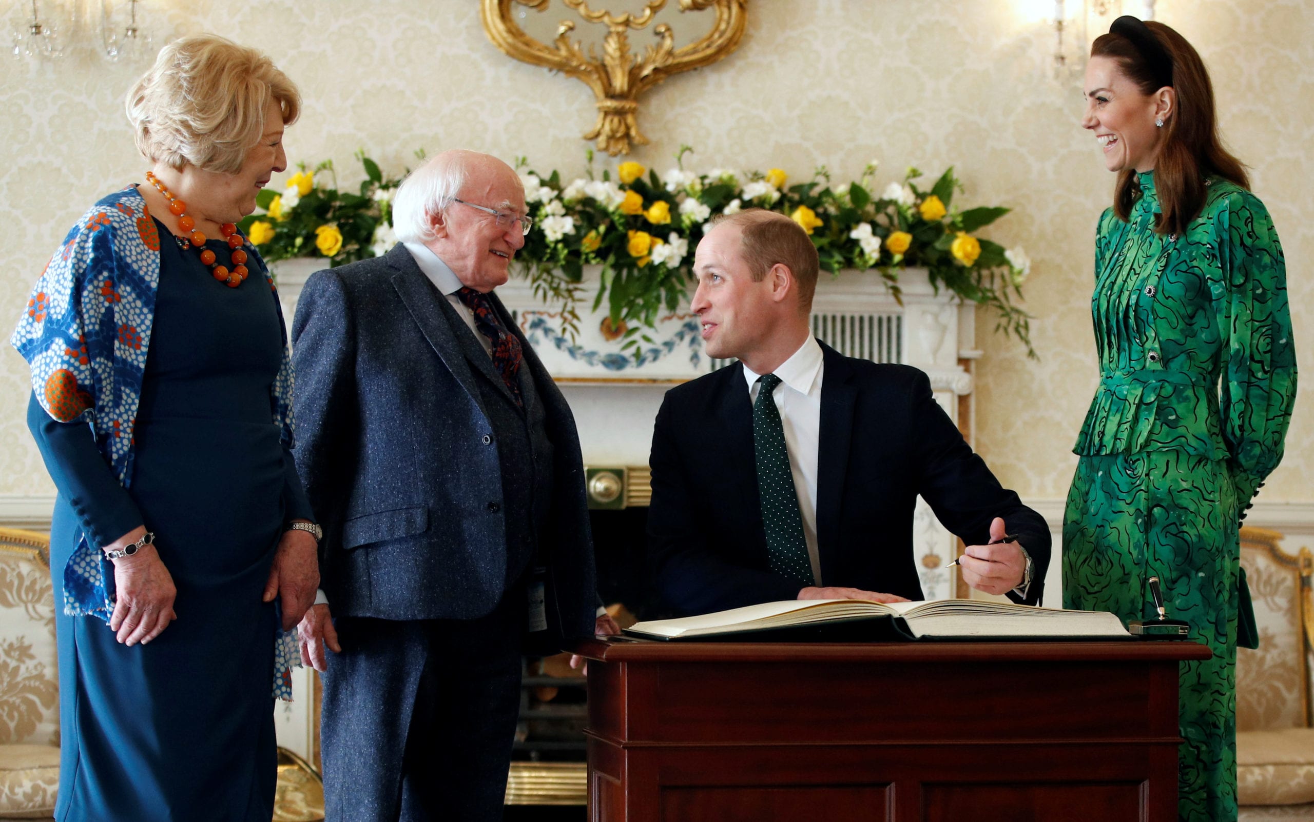 Britain's Prince William sings a visitors book next to his wife Catherine, Duchess of Cambridge, as they meet with Ireland's President Michael D. Higgins and his wife Sabina, at the official presidential residence Aras an Uachtarain in Dublin, Ireland, March 3, 2020. REUTERS/Phil Noble/Pool