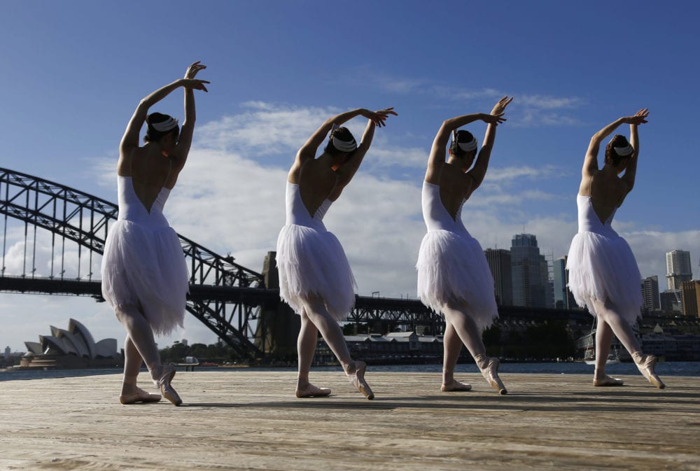 Ballerinas from The Australian Ballet perform on a floating platform, during an event in front of the Sydney Opera House