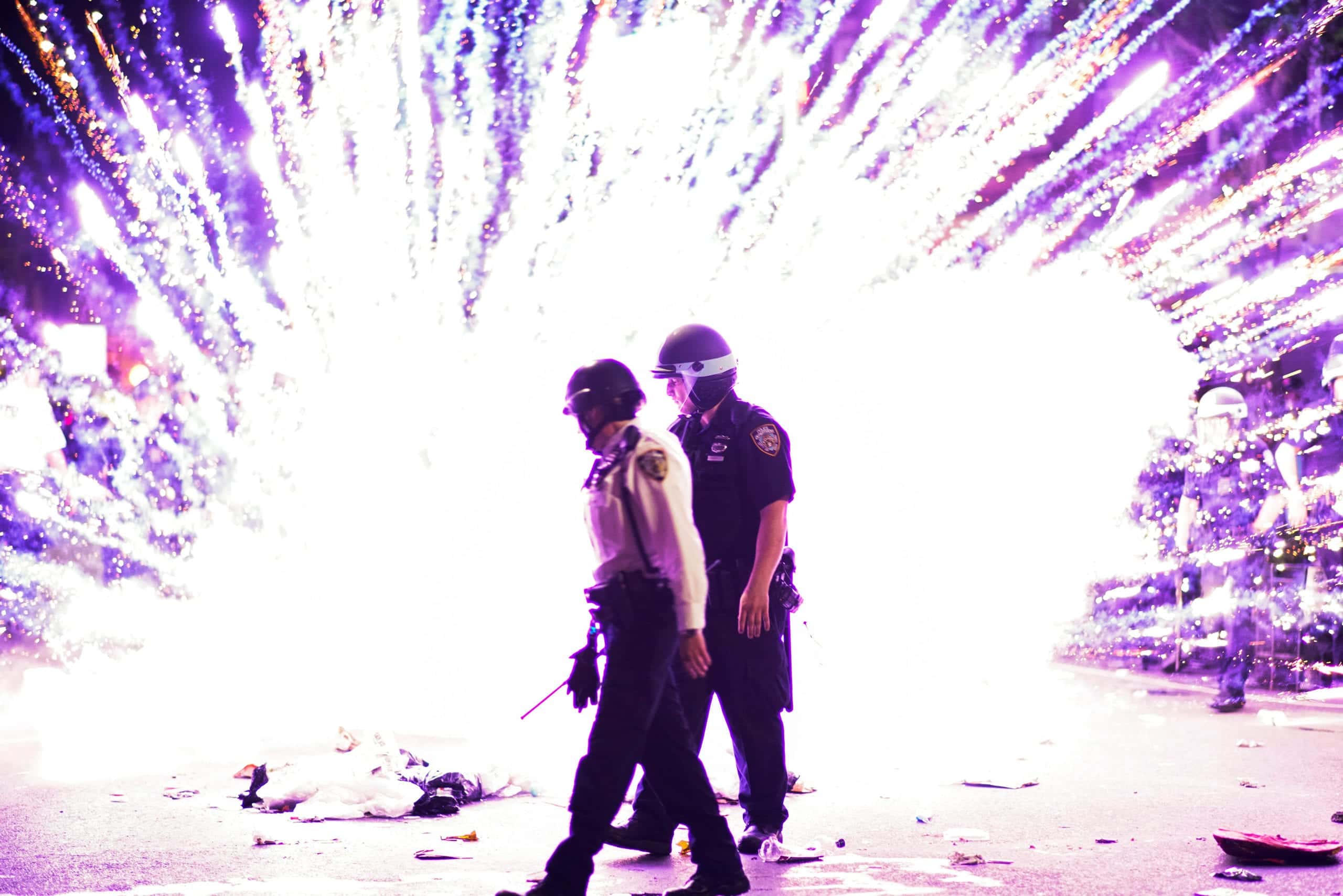 NYPD officers walk near an explosion caused by an unidentified dispositive as they clash with protesters during a march against the death in Minneapolis police custody of George Floyd, in the Brooklyn borough of New York City, U.S., May 30, 2020. REUTERS/Eduardo Munoz - RC2HZG9OKBRH