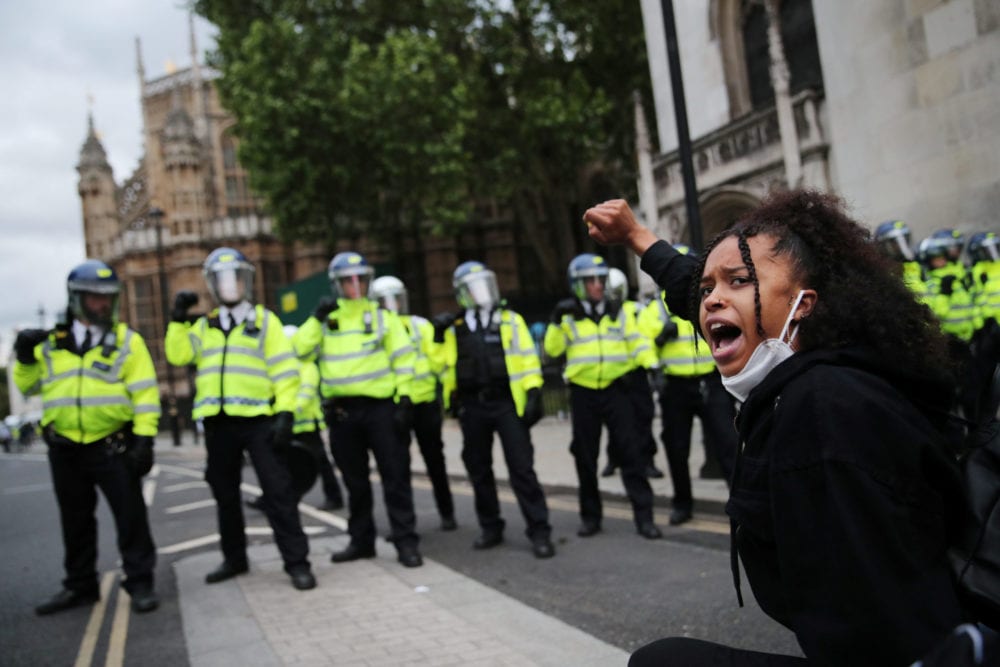 <em>A woman gestures in front of police officers during a Black Lives Matter protest in London, following the death of George Floyd who died in police custody in Minneapolis, London</em>