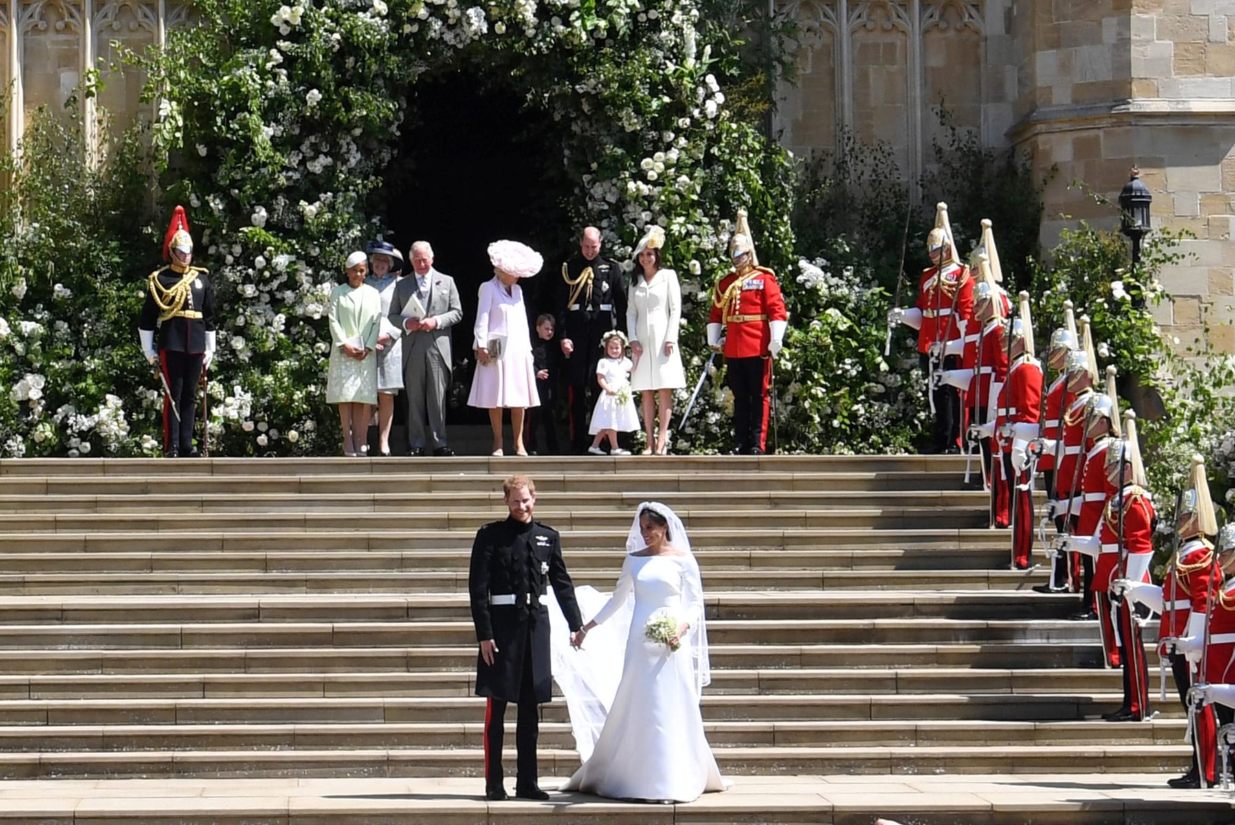 Britain's Prince Harry (L), Duke of Sussex and Meghan (R), Duchess of Sussex exit St George's Chapel in Windsor Castle after their royal wedding ceremony, in Windsor, Britain, 19 May 2018. The couple have been bestowed the royal titles of Duke and Duchess of Sussex on them by the British monarch.  NEIL HALL/Pool via REUTERS - RC13A9C94CA0