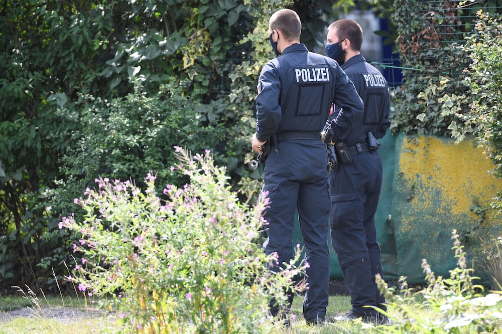 Police walk near the site where they started digging in an allotment area near Hanover, Germany July 29, 2020, where Christian B, a suspect in the Madeleine McCann investigation lived for a while some years ago.     REUTERS/Fabian Bimmer