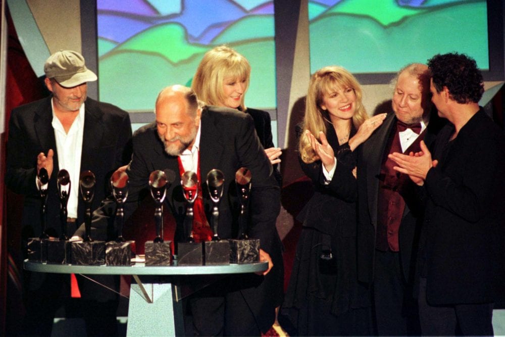 Members of the band Fleetwod Mac appear at the podium after being inducted into the Rock and Roll Hall of Fame at the Rock and Roll Hall of Fame Foundation's Thirteenth Annual Induction Dinner at New York's Waldorf Astoria Hotel, January 12. From left are John McVie, Mick Fleetwood, Christine McVie, Stevie Nicks, Peter Green and Lindsey Buckingham. - PBEAHULYNAR