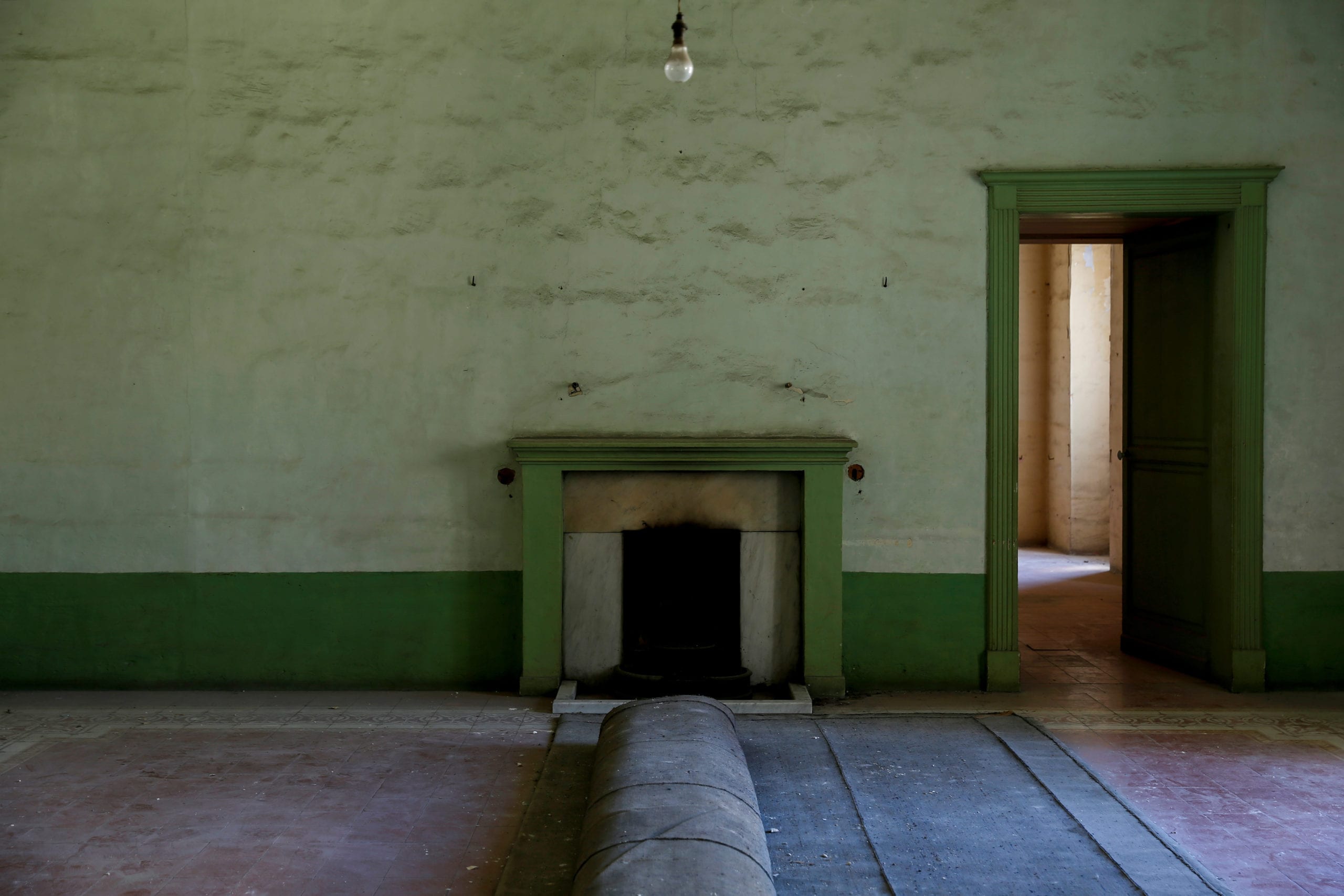 A rolled-up carpet is left in front of a fireplace, inside a room that was once used as the grand hall for receiving guests at Villa Guardamangia, a former residence of Britain's Queen Elizabeth and Prince Philip, in Pieta, Malta, June 23, 2020. The then-Princess Elizabeth and Prince Philip were in the first years of their marriage at the time and moved to Malta when Prince Philip was based there in command of a Royal Navy frigate. The Maltese government agency Heritage Malta acquired the Villa Guardamangia for some five million euros and hopes not just to restore the villa to the way it looked several decades ago, but also to turn it into a museum of Malta's history as a British colony until independence in 1964, and the links with the British royal family. REUTERS/Darrin Zammit Lupi     SEARCH "QUEEN ELIZABETH VILLA" FOR THIS STORY. SEARCH "WIDER IMAGE" FOR ALL STORIES