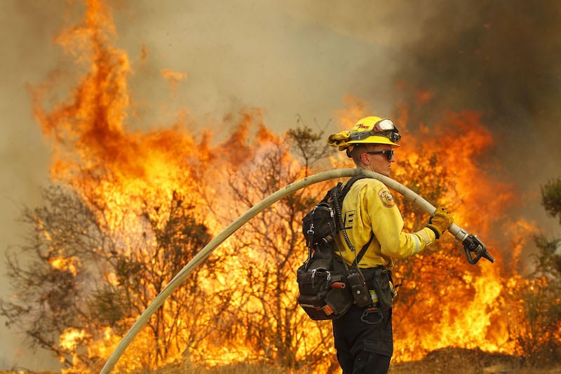 A firefighter takes part in an operation near Montiel Truck Trail to put out flames that broke out due to ongoing raging wildfires.