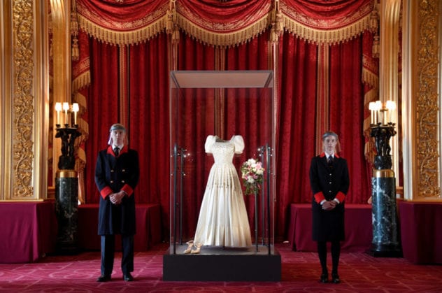 Two Windsor Castle wardens view the wedding dress worn by Princess Beatrice of York at her July 2020 wedding, which was originally worn by Britain's Queen Elizabeth in the 1960s, ahead of it going on public display at Windsor Castle, Windsor, Britain, September 23, 2020. REUTERS/Toby Melville