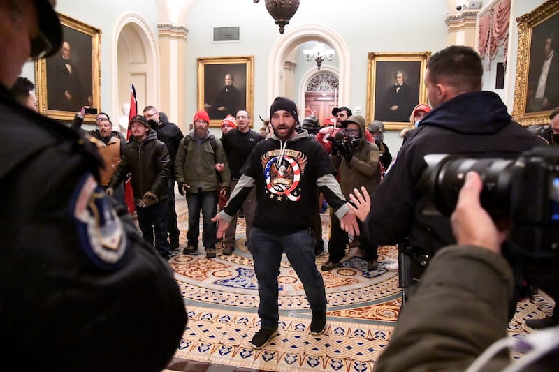 A supporter of President Donald Trump confronts police as Trump supporters demonstrate on the second floor of the U.S. Capitol near the entrance to the Senate after breaching security defenses, in Washington, U.S., January 6, 2021.         REUTERS/Mike Theiler
