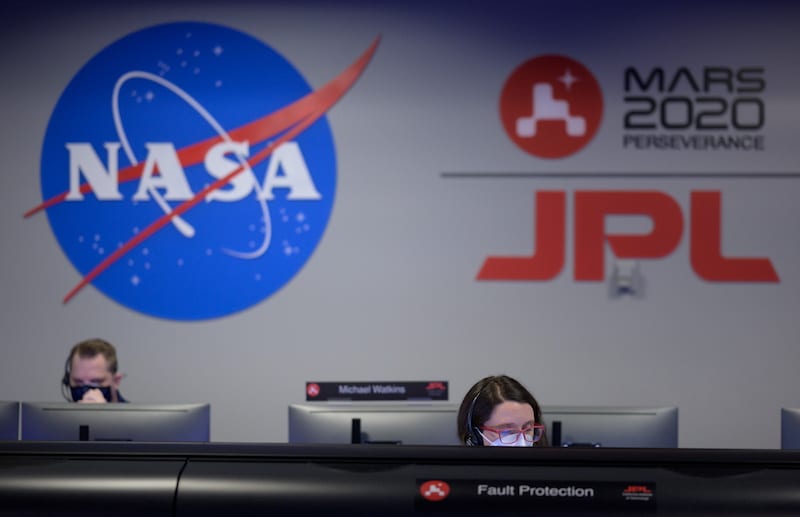 Members of NASA’s Perseverance Mars rover team study data on monitors in mission control at NASA's Jet Propulsion Laboratory in Pasadena, California, U.S. February 18, 2021.    NASA/Bill Ingalls/Handout via REUTERS