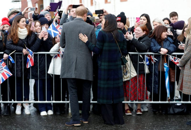 FILE PHOTO: Meghan Markle, and Britain's Prince Harry, meet members of the crowd as they arrive for a visit to Edinburgh, Scotland February 13, 2018. REUTERS/Russell Cheyne/File Photo