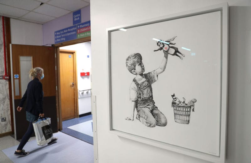 Artwork painted by Banksy during lockdown, entitled 'Game Changer', on display to staff and patients at Southampton General Hospital. (Photo by Andrew Matthews/PA Images via Getty Images)