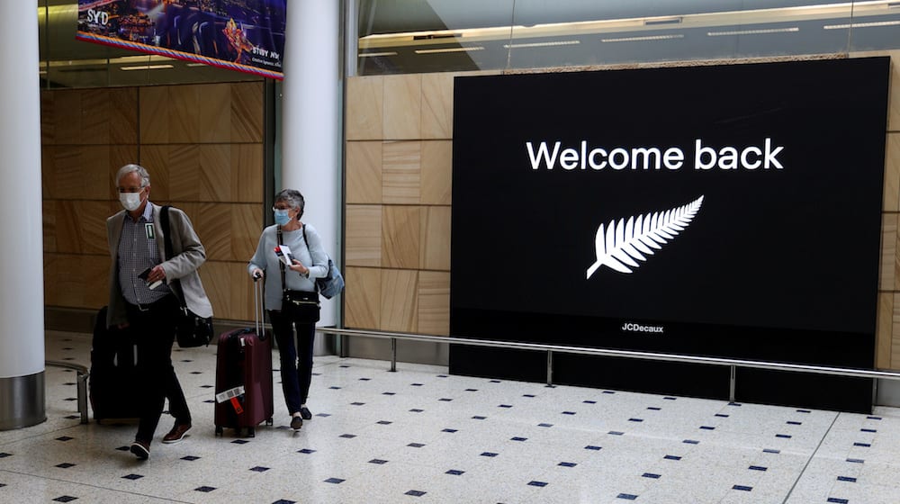 FILE PHOTO: Passengers arrive from New Zealand after the Trans-Tasman travel bubble opened overnight, following an extended border closure due to the coronavirus disease (COVID-19) outbreak, at Sydney Airport in Sydney, Australia, October 16, 2020. REUTERS/Loren Elliott/File Photo