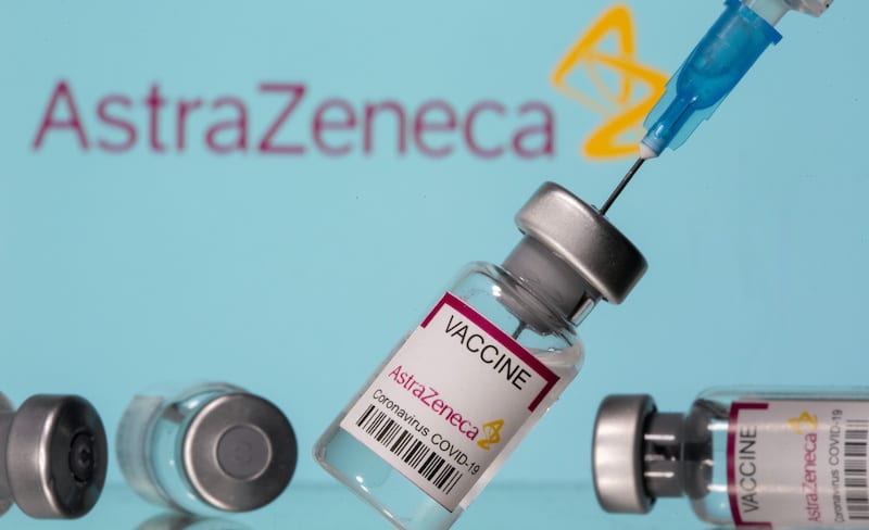 FILE PHOTO: Vials labelled "Astra Zeneca COVID-19 Coronavirus Vaccine" and a syringe are seen in front of a displayed AstraZeneca logo, in this illustration photo taken March 14, 2021. REUTERS/Dado Ruvic/Illustration/File Photo