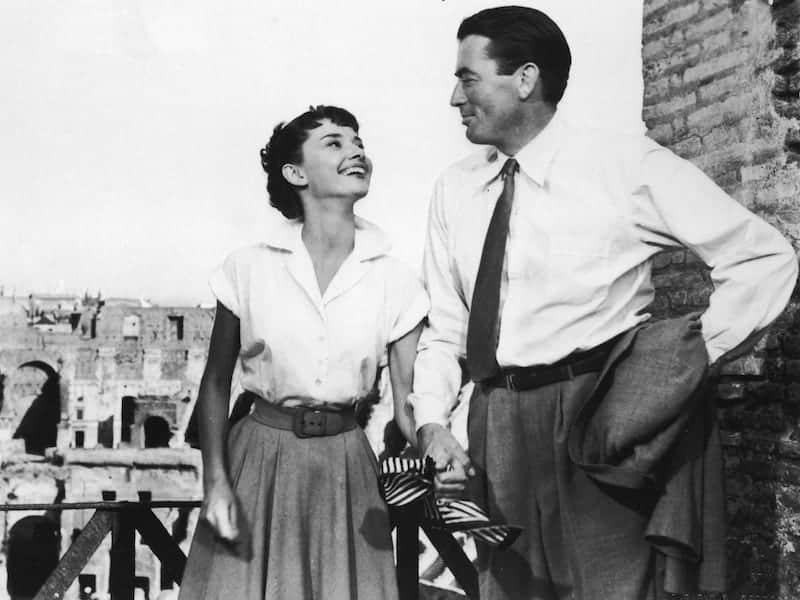 Audrey Hepburn holds the hand of American actor Gregory Peck in a still from the film 'Roman Holiday,' directed by William Wyler, 1953. (Photo by Paramount Pictures/Courtesy of Getty Images)