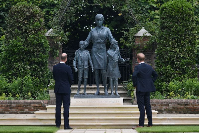 Britain's Prince William, The Duke of Cambridge, and Prince Harry, Duke of Sussex, look at a statue they commissioned of their mother Diana, Princess of Wales, in the Sunken Garden at Kensington Palace, London, Britain July 1, 2021. Dominic Lipinski/Pool via REUTERS