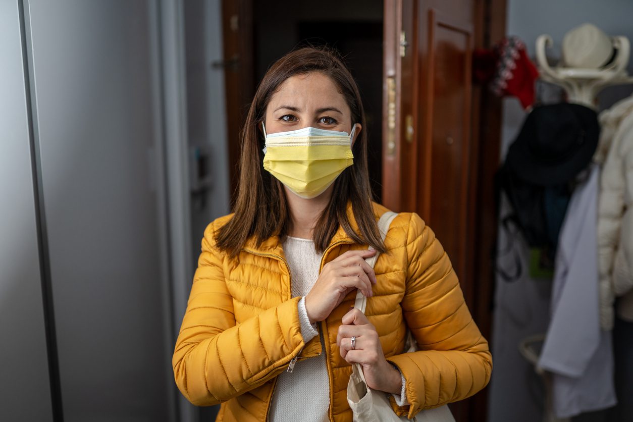 Young Woman wearing double face mask before going out