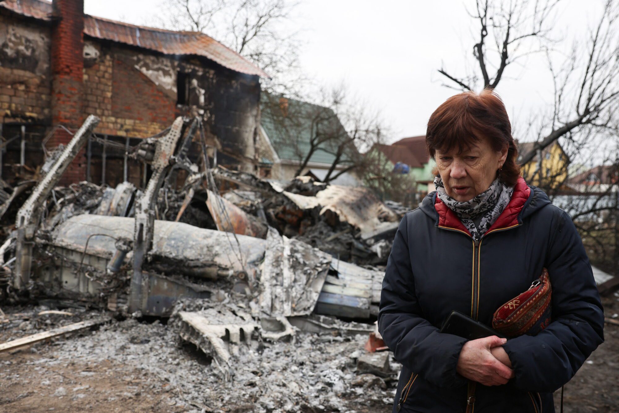 A person walks around the wreckage of an unidentified aircraft that crashed into a house in a residential area, after Russia launched a massive military operation against Ukraine, in Kyiv, Ukraine February 25, 2022. REUTERS/Umit Bektas