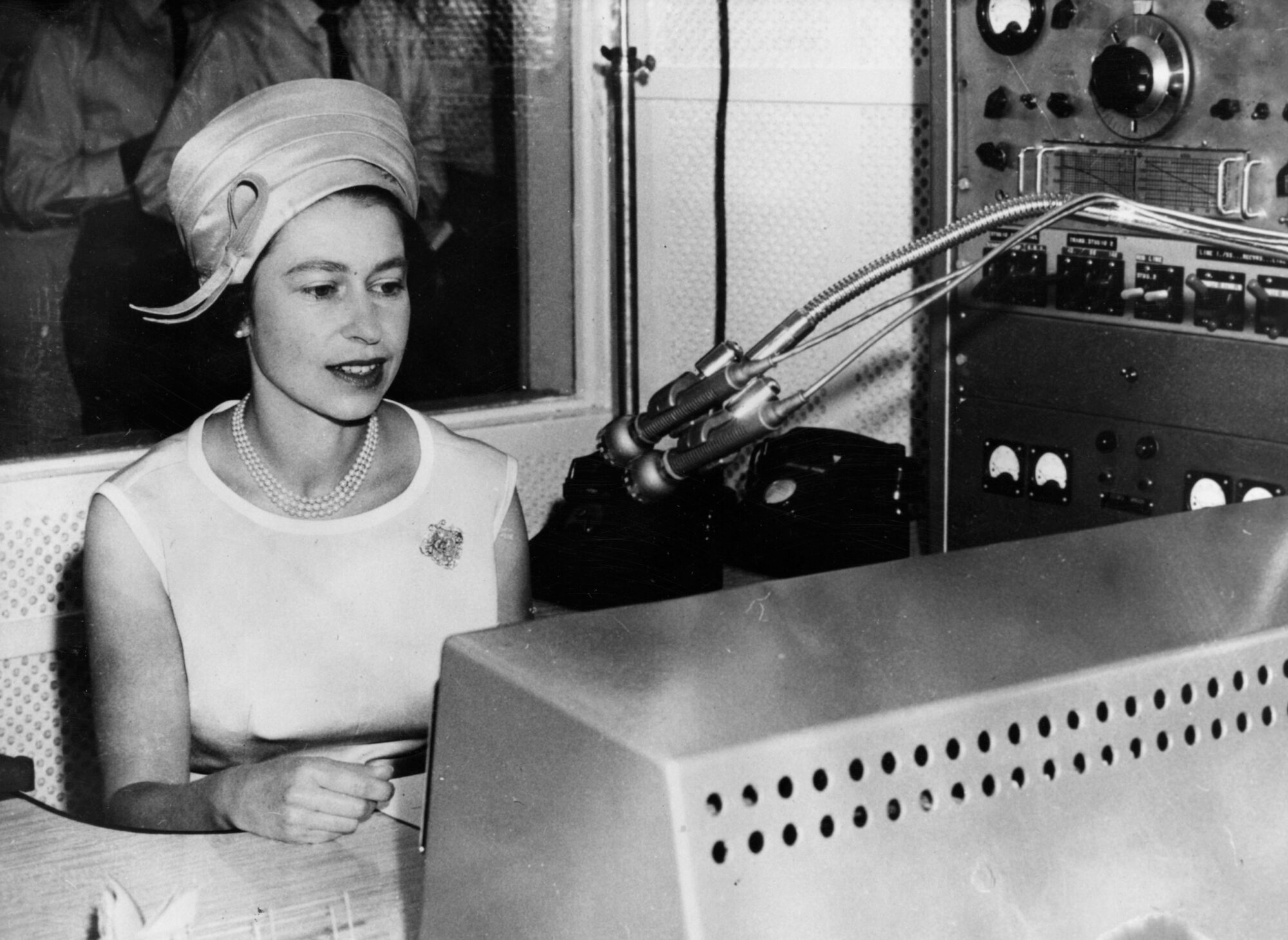 18th March 1963:  Queen Elizabeth II using a Flying Doctor Service radio to address the people of Alice Springs, Australia during a visit to the town's flying doctor base.  (Photo by Central Press/Getty Images)