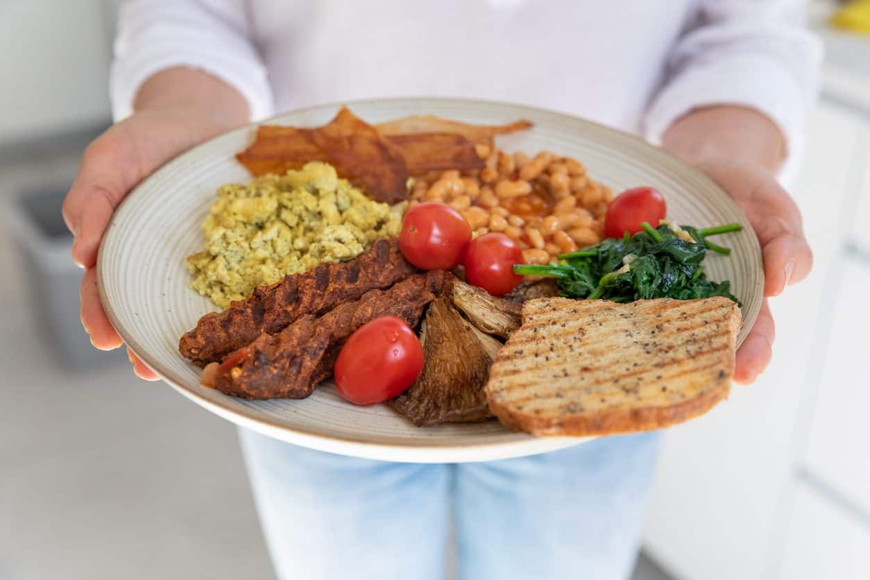 Female chef holds vegetarian breakfast