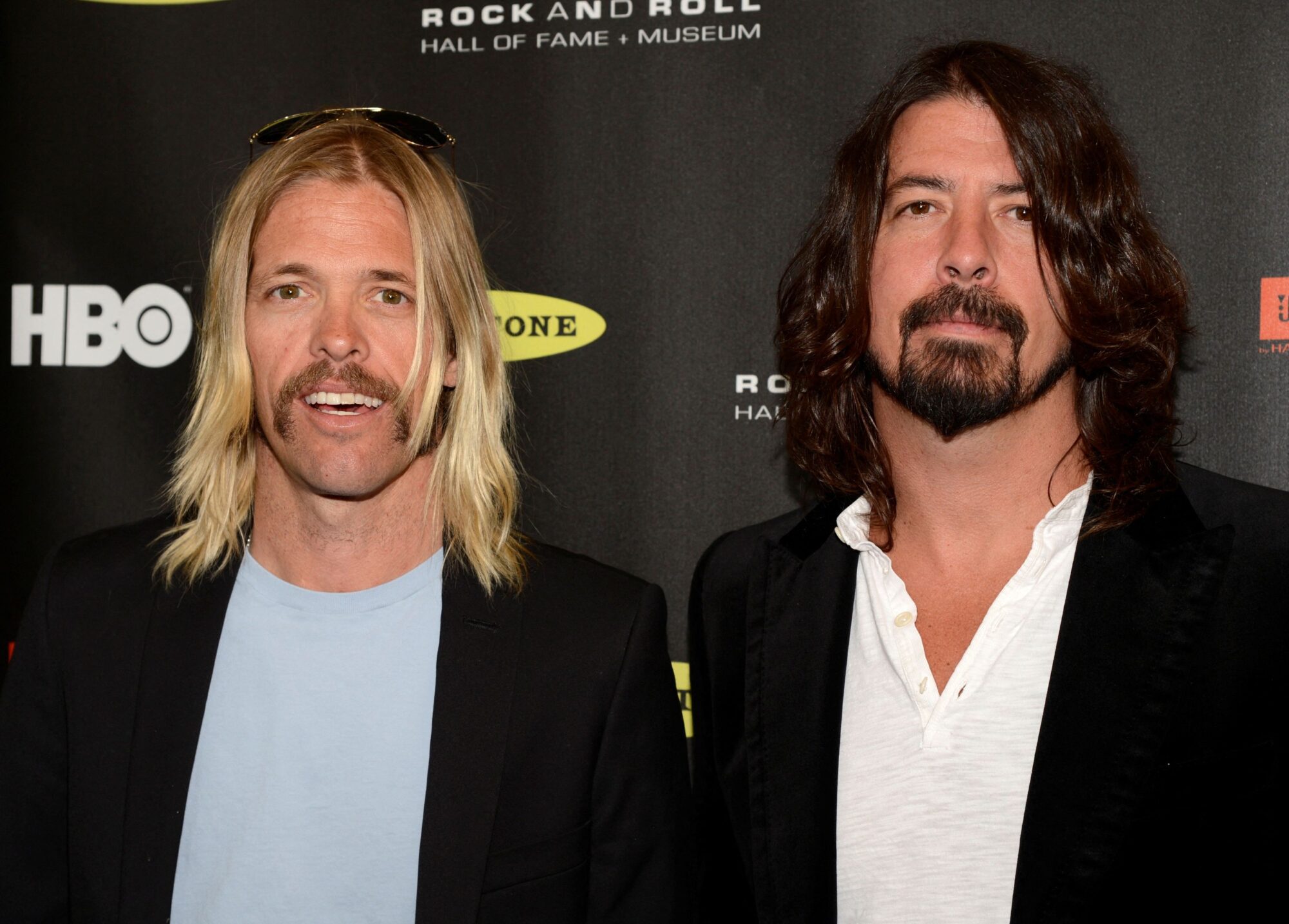Taylor Hawkins and Dave Grohl of the Foo Fighters arrive at the 2013 Rock and Roll Hall of Fame induction ceremony in Los Angeles April 18, 2013. REUTERS/Phil McCarten/File Photo