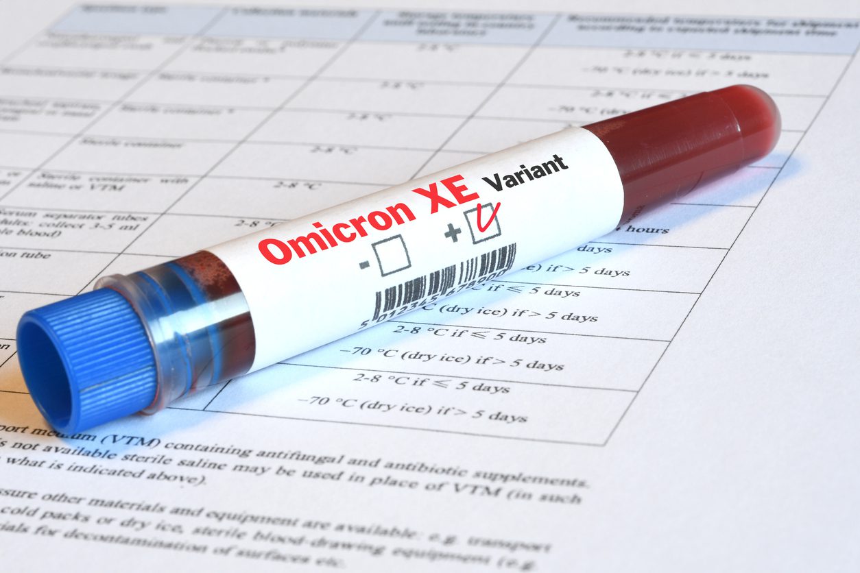 Blood tube for test detection of virus Covid-19 Omicron XE Variant with positive result on papers document.