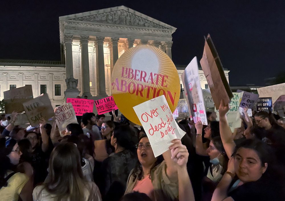 Protestors react outside the U.S. Supreme Court to the leak of a draft majority opinion written by Justice Samuel Alito preparing for a majority of the court to overturn the landmark Roe v. Wade abortion rights decision later this year, in Washington, U.S., May 2, 2022. REUTERS/Moira Warburton
