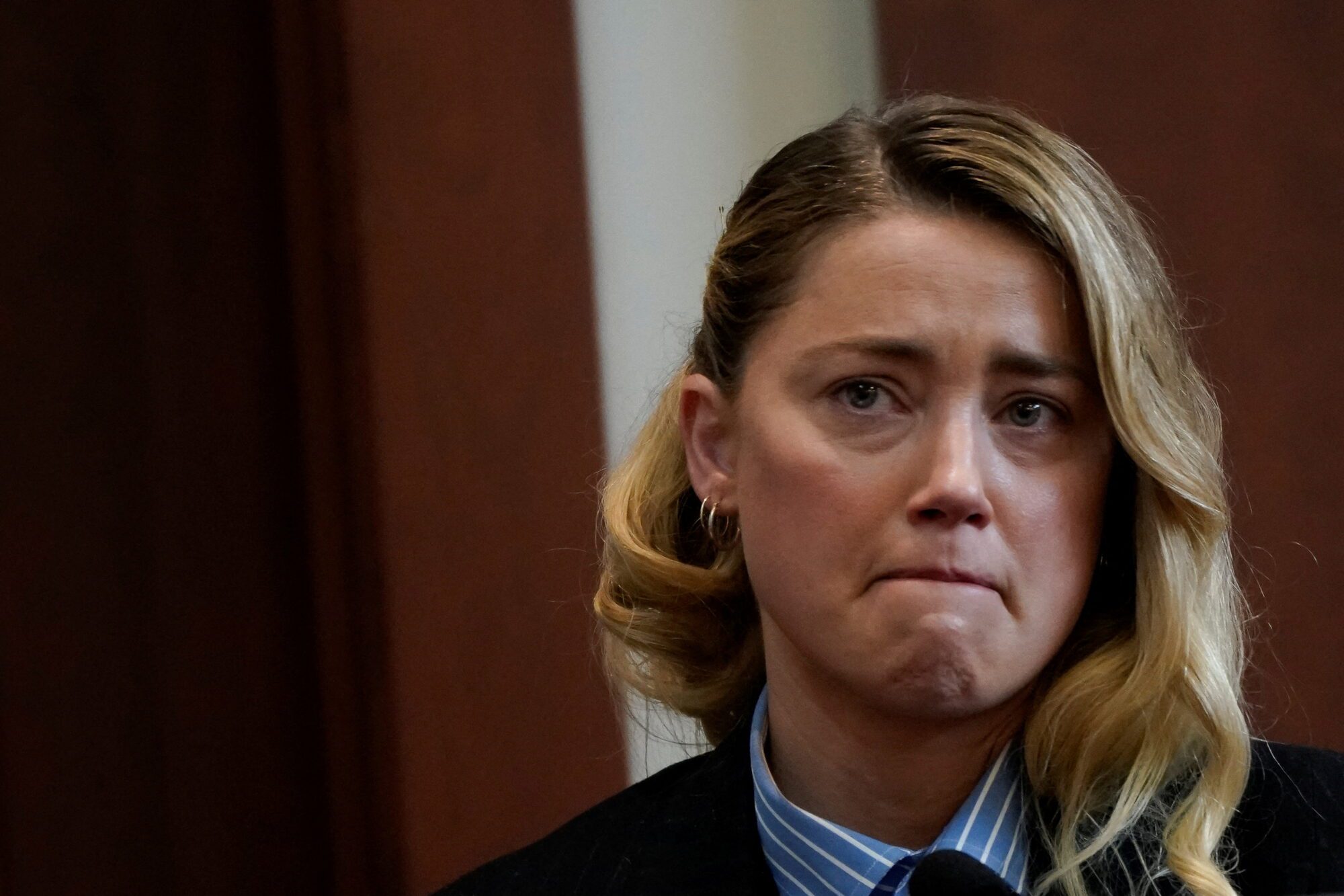 Actor Amber Heard testifies about the first time she says her ex-husband, actor Johnny Depp hit her, at Fairfax County Circuit Court during a defamation case against her by Depp in Fairfax, Virginia, U.S., May 4, 2022. REUTERS/Elizabeth Frantz/Pool