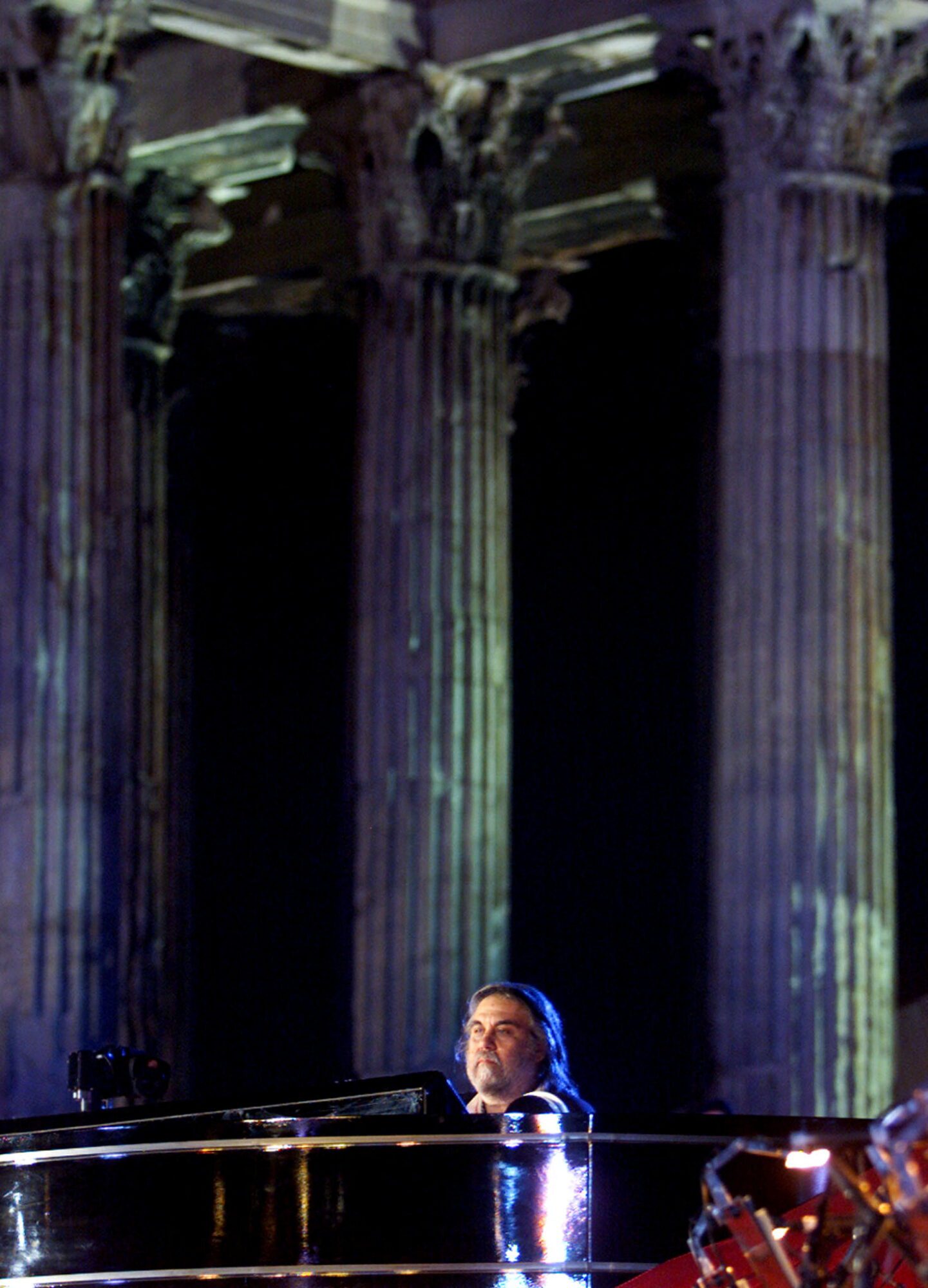 FILE PHOTO: Greek composer Vangelis performs during a concert at the Temple of Zeus in Athens on June 28, 2001. Vangelis presented a 60-minute composition entitled Mythodea./File Photo