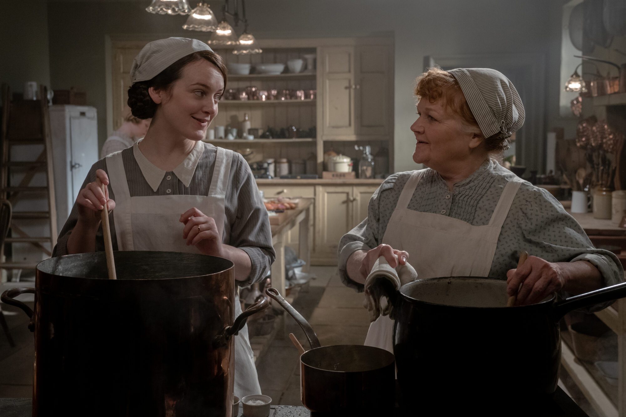 Sophie McShera stars as Daisy and Lesley Nicol stars as Mrs. Patmore in DOWNTON ABBEY