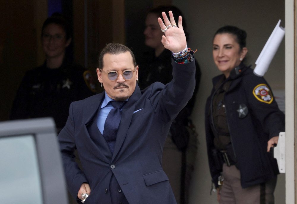FILE PHOTO: Actor Johnny Depp gestures as he leaves the Fairfax County Circuit Courthouse following his defamation trial against his ex-wife Amber Heard, in Fairfax, Virginia, U.S., May 27, 2022. REUTERS/Evelyn Hockstein