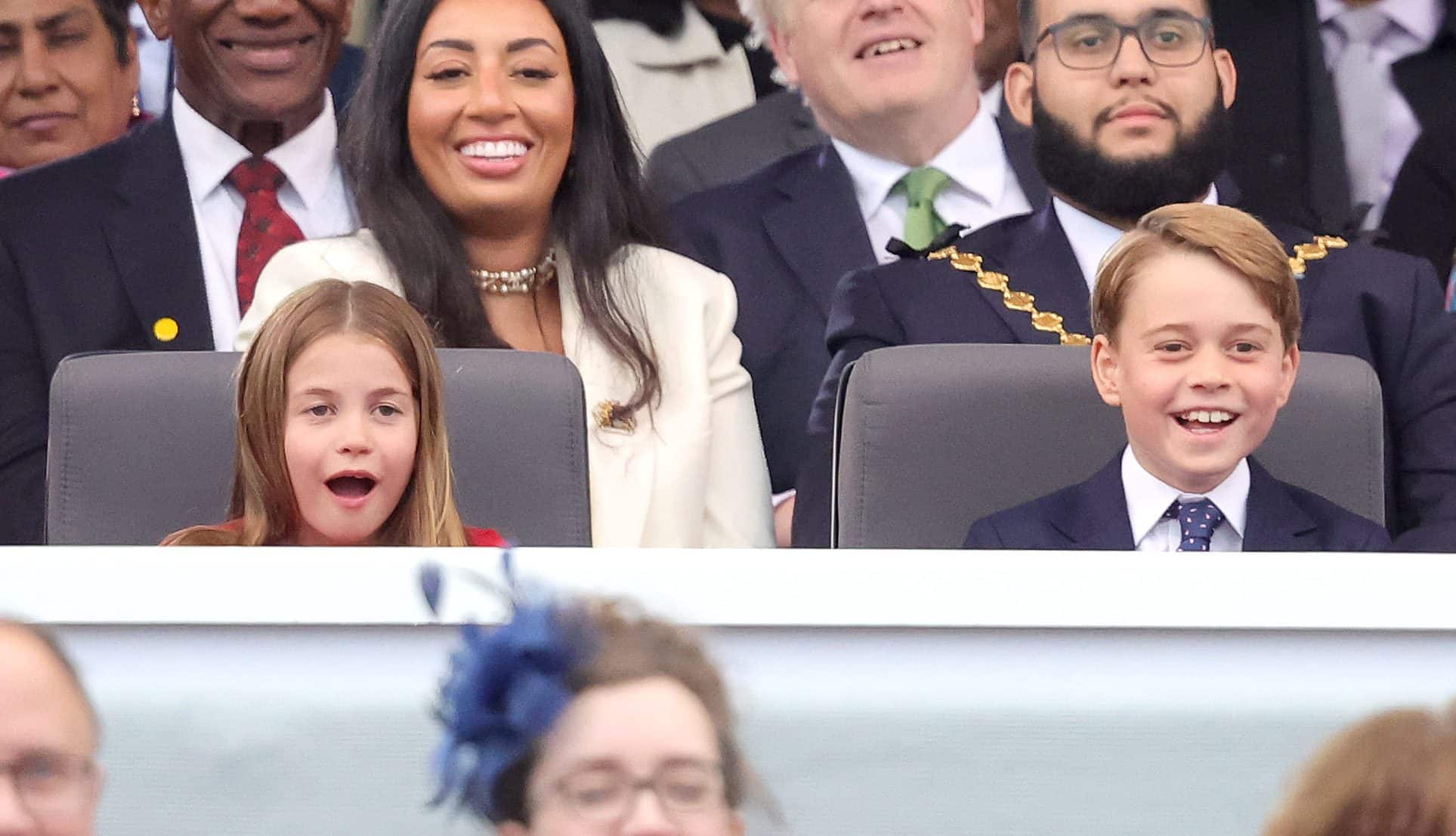 Princess Charlotte and Prince George can't believe their luck as they watch Paddington Bear and HM The Queen