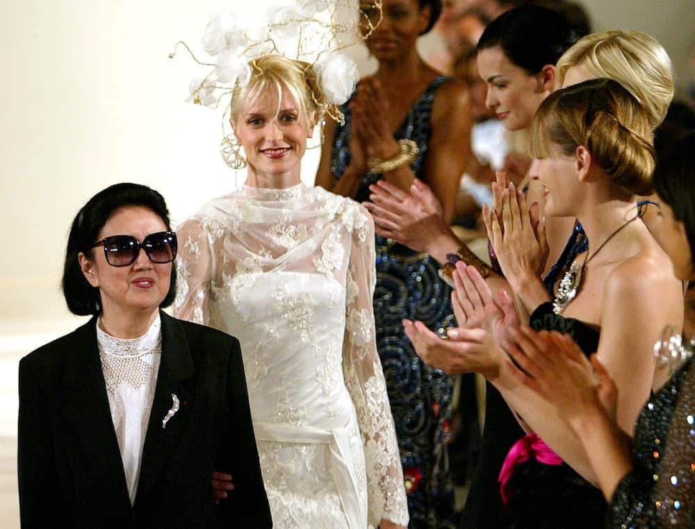 FILE PHOTO: Models applaud Japanese designer Hanae Mori (L) at the end of her Haute Couture 2003-2004 Autumn-Winter collection in Paris, July 9, 2003.