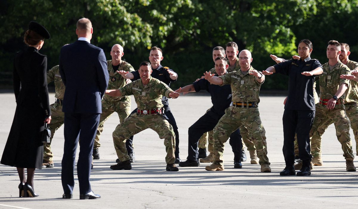 New Zealand's soldiers perform the haka for the Prince and Princess of Wales. REUTERS
  
