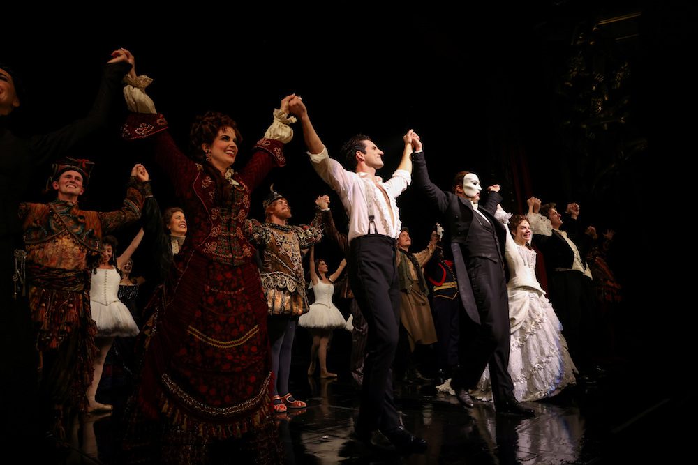 FILE PHOTO: Cast members stand on the stage after performing on the re-opening night of "Phantom of the Opera" at the Majestic Theater in New York City