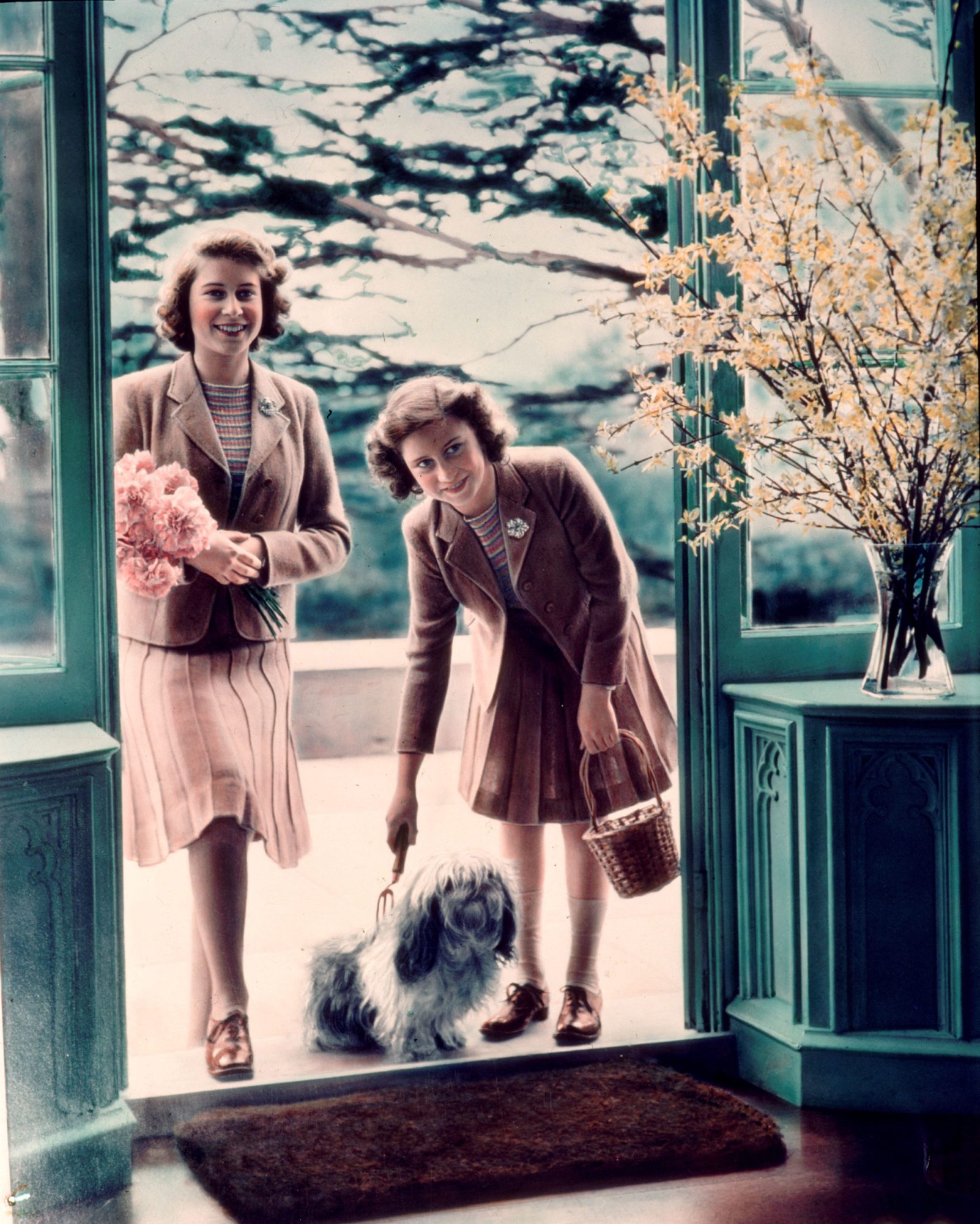 <em>Princesses Elizabeth and Margaret plus canine friend outside the Royal Lodge, Windsor, in 1942</em>