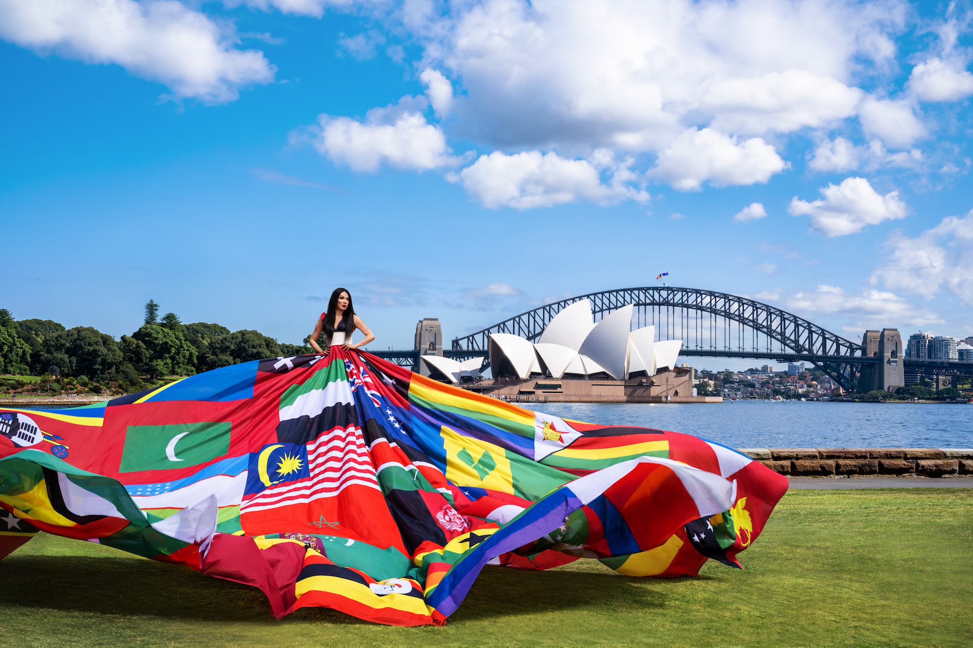 Actor, theatre critic and trans woman, Suzy Wrong models the Amsterdam Rainbow Dress in front of the Sydney Harbour Bridge, credit: Cassandra Hannagan</em>