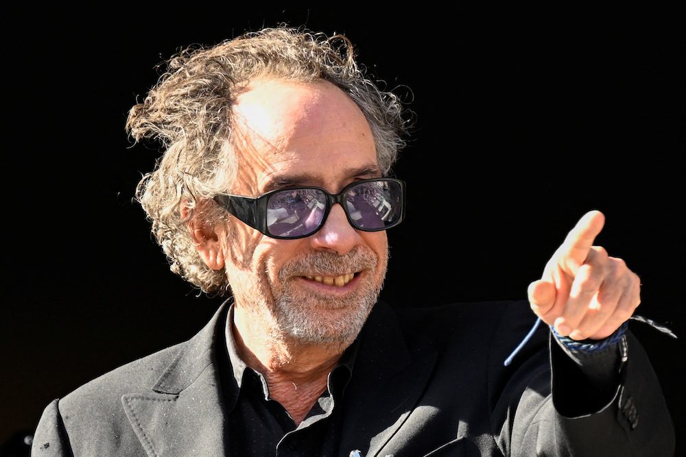FILE PHOTO: Film director Tim Burton greets fans from a balcony during the Lucca Comics and Games for the premiere of Netflix's new series 'Wednesday' in Lucca, Italy, October 31, 2022. REUTERS/Flavio Lo Scalzo/File Photo