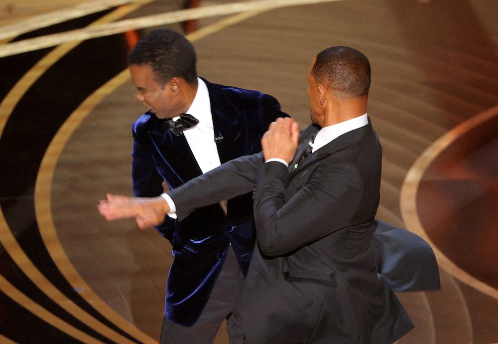 FILE PHOTO: Will Smith hits Chris Rock onstage during the 94th Academy Awards in Hollywood, Los Angeles, California, U.S., March 27, 2022.        REUTERS/Brian Snyder