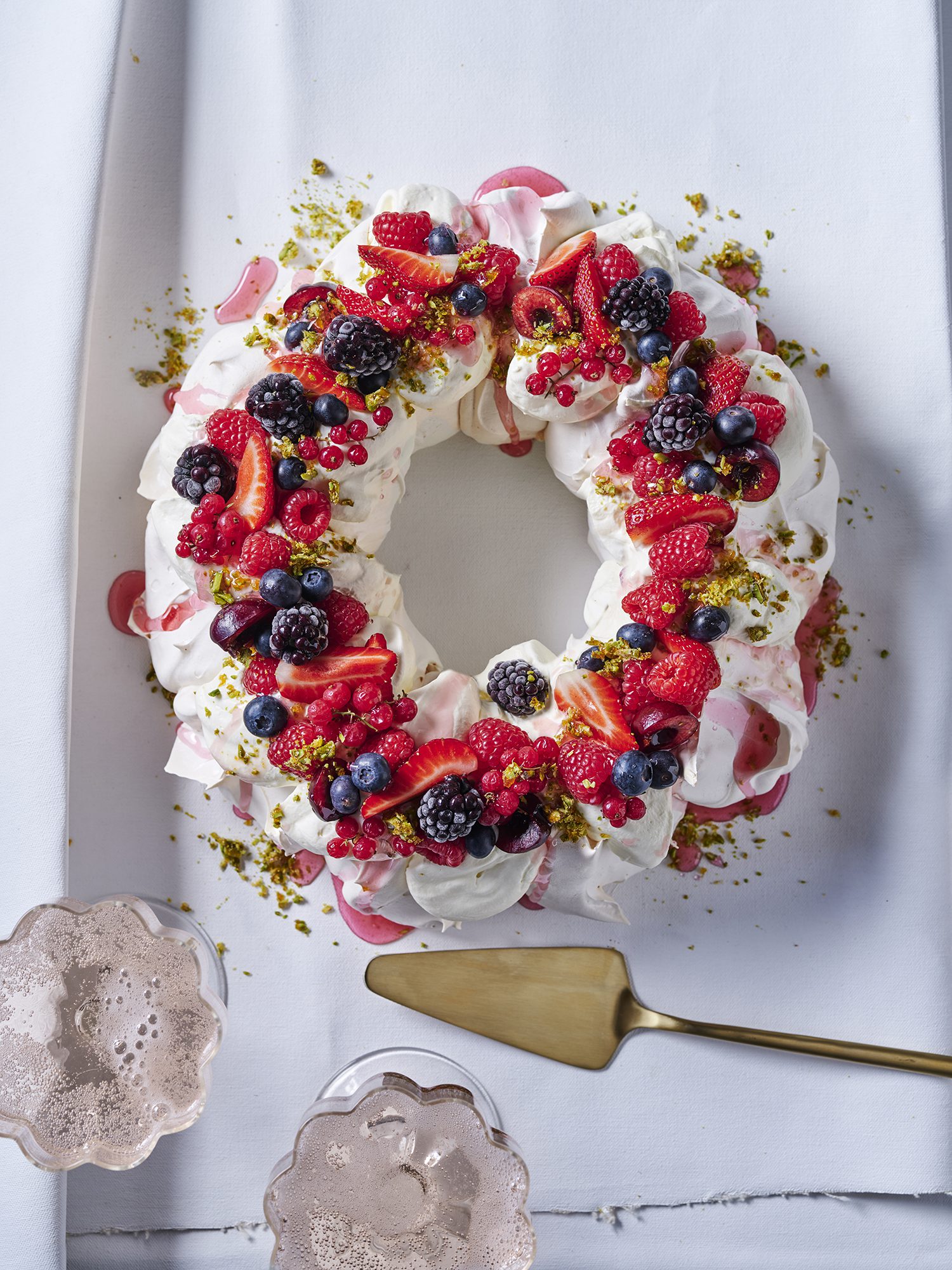 Festive Berry Wreath Pavlova with Pink Prosecco Syrup and Candied Pistachios
