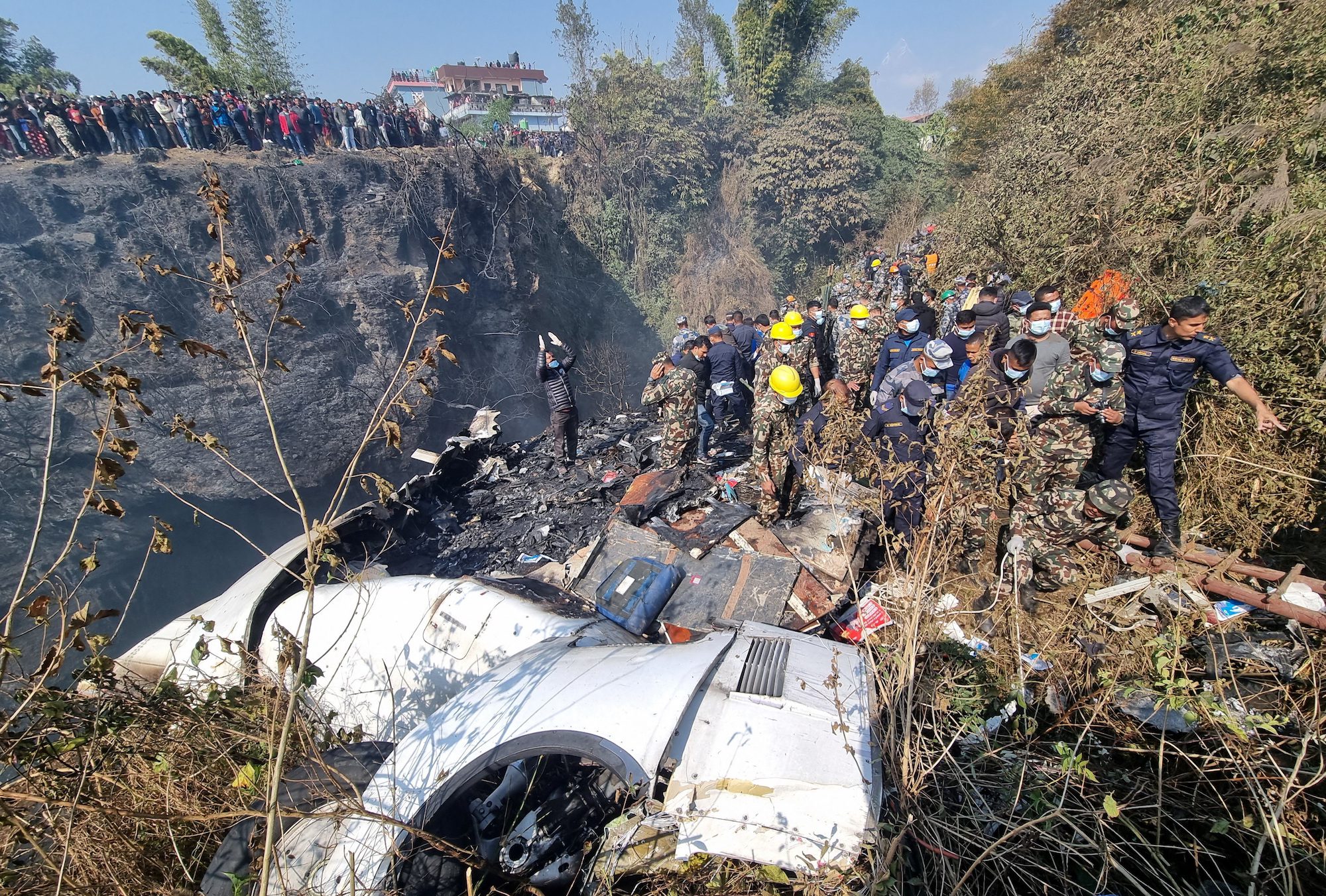 Rescue teams work to retrieve bodies at the crash site of an aircraft carrying 72 people in Pokhara in western Nepal January 15, 2023. Bijay Neupane/Handout via REUTERS